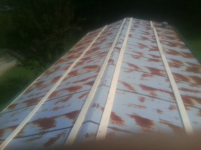 Rusted metal roof panels with new wood purlins before replacement — Storm Damage Roof Repair in Suisun City by Roofing Brothers