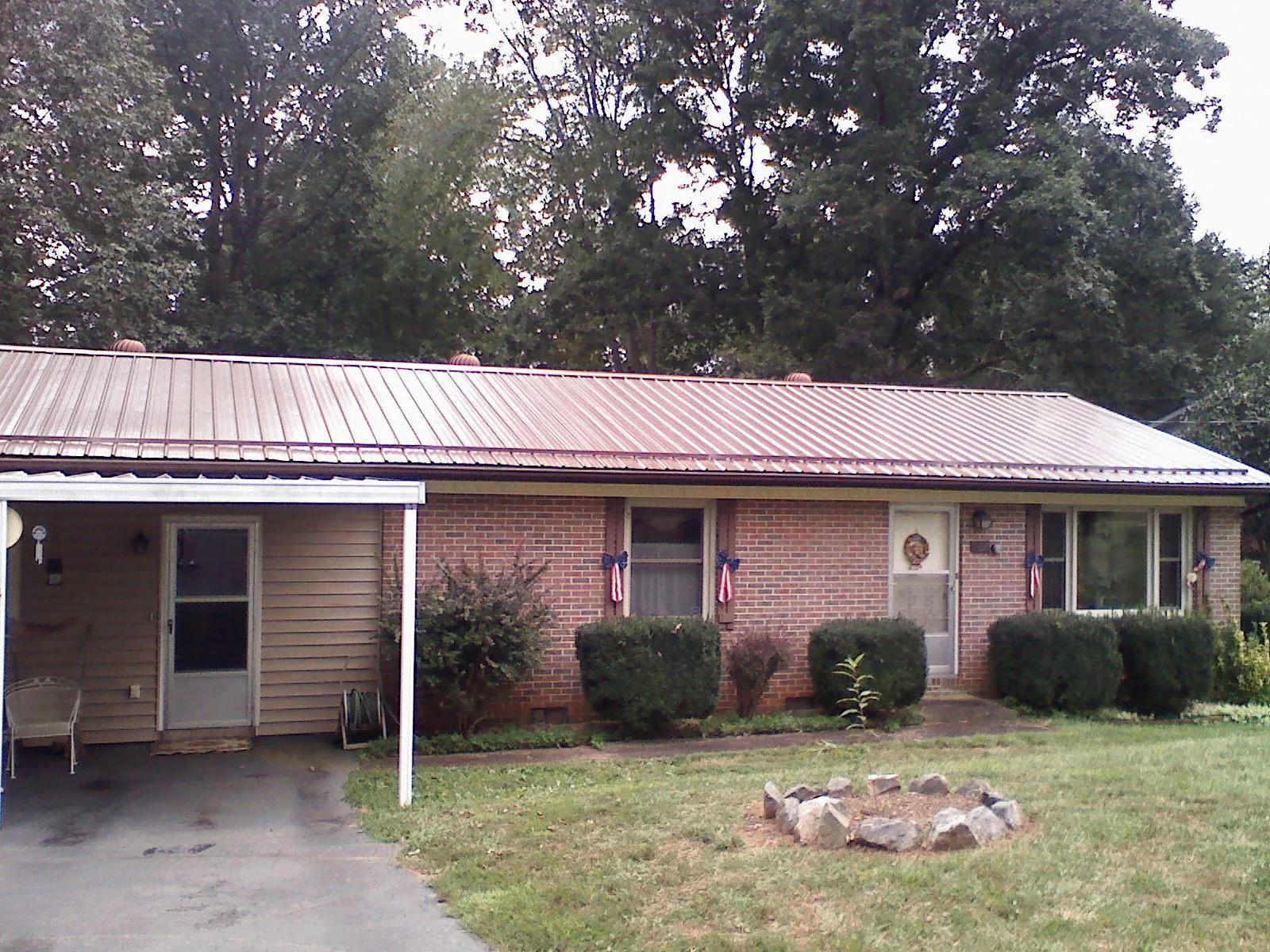 Bronze metal roof and carport on a brick ranch home — Roof Repair work by our crew in Suisun City