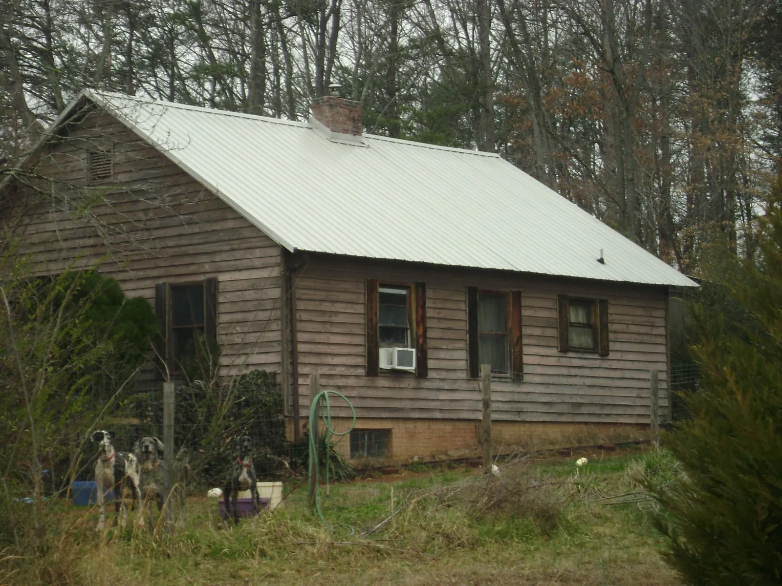White metal roof on an old wood sided farmhouse, from a Metal Roof Installation job in Suisun City